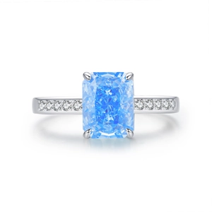 S925 sterling silver ring with rectangular blue zircon and side stones on white background