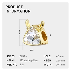 Macro detail of gold reindeer charm in 925 silver with sparkling clear crystal stones