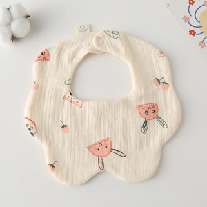 Close-up of soft cotton gauze baby bib with cartoon bunny and cherry patterns