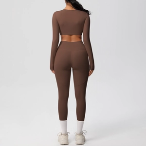 Rear view of women's yoga set featuring cropped long sleeve top and high-waist chocolate leggings
