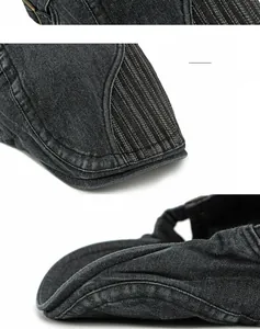 Détails de la visière incurvée et coutures blanches sur le béret en denim gris foncé