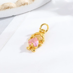 Detailed view of golden girl pendant with a pink heart stone for DIY jewelry making
