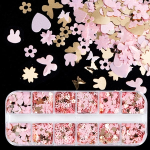 Pink and gold butterfly heart nail sequins in a 12-grid storage box for DIY craft