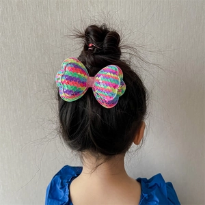 Sparkly sequins double-layered bow hair clip for girls shown on a child's hairstyle