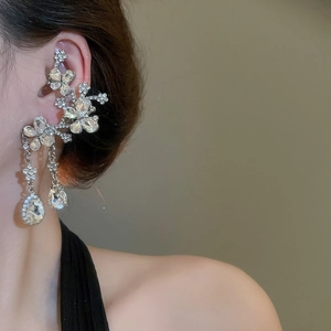 Close-up of silver flower ear cuff with sparkling rhinestone tassels and waterdrop crystal