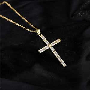 Elegant 18K gold plated cross necklace with rectangular zircon crystals on black fabric