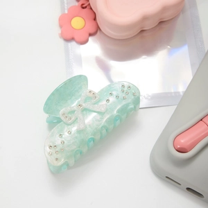 Mint green acetate shark hair claw with white ribbon and sparkling rhinestones