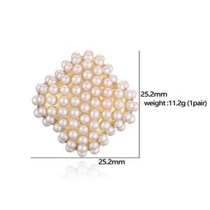 Elegant square cluster earrings with white pearls and gold base on a white background