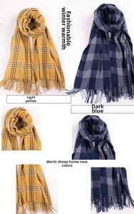 Close-up of winter plaid cashmere scarf with tassel edges in light yellow and dark blue