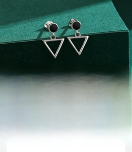 Macro shot of S925 sterling silver hollow triangle earrings with polished finish