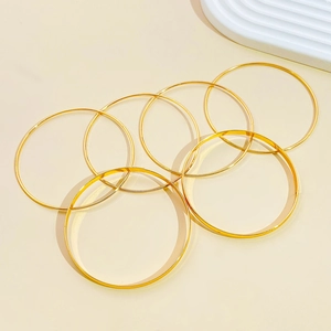 Set of 6 minimalist gold-plated bangles with high-polished smooth surface finish
