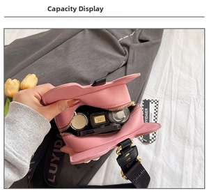 Interior view of the pink leather guitar bag showing capacity for cosmetics and accessories