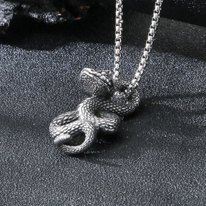 Close-up of a punk snake pendant with realistic scales and a durable box chain necklace