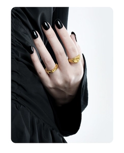 Macro detail of retro textured gold rings on model showing intricate relief patterns