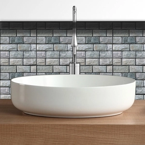 Detail of white ceramic countertop washbasin with sleek chrome single-hole faucet