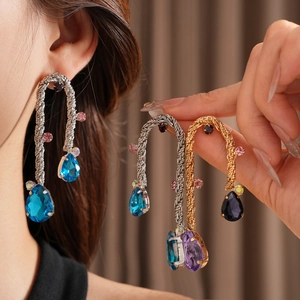 Detailed close-up of vintage metal weave earrings featuring colorful teardrop gemstones
