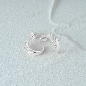 Close-up of S925 sterling silver C-shaped earrings featuring micro-pave white cubic zirconia