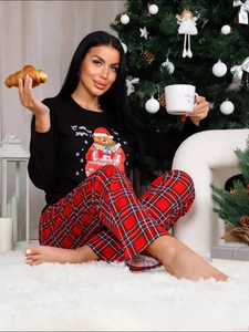 Close-up of women's Christmas pajama set with bear print top and red plaid pants