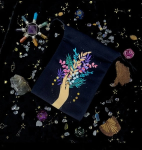 Detailed view of velvet tarot drawstring bag featuring an artistic botanical hand print