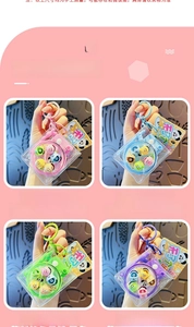 Close-up of rotating fishing game keychains in pink, blue, green, and purple cases