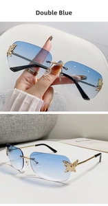 Macro detail of rimless blue gradient lenses with decorative gold crystal butterfly