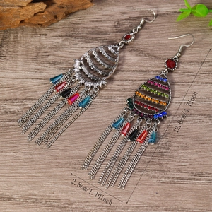 Detail of bohemian tassel earrings with colorful rhinestones and vintage silver finish