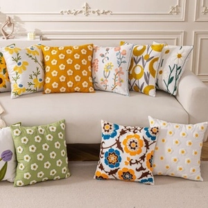 Detail of luxury American style floral embroidery square pillows on a beige sofa