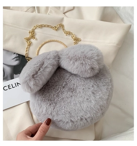Close-up of grey plush bag with cute ears, golden chain strap, and metallic handle ring