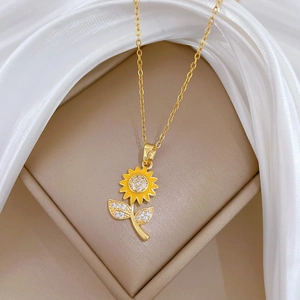 Macro detail of sunflower pendant with yellow petals and sparkling crystals on golden chain