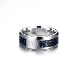 Macro view of 8mm stainless steel ring with blue black carbon fiber and Dad engraving