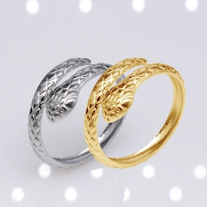 Detailed macro view of gold and silver snake rings with intricate scale textures