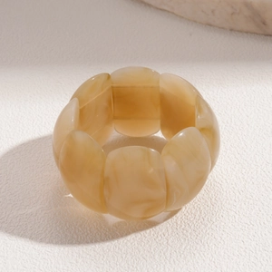 Macro detail of Bohemian resin bangle showing marble texture and petal-shaped segments