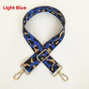 Detail of adjustable leopard print shoulder strap in light blue with gold metal hooks
