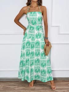 Detailed close-up of the tropical palm print on this green and white halter neck maxi dress