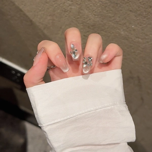 Handmade cat eye press-on nails with butterfly rhinestone decor in long square shape