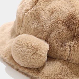 Macro close-up of soft brown plush faux fur material on the warm winter cat ear bucket hat