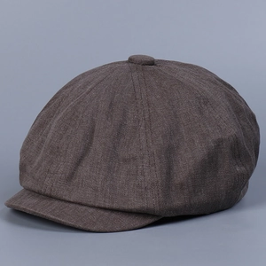 Detailed close-up of dark brown vintage flat cap showing thick twill fabric texture