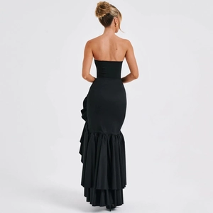 Detail of layered ruffled fishtail hem on a black strapless evening dress, back view