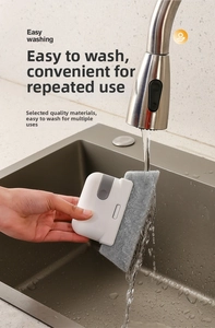 Washable handheld window groove cleaning tool with gray scouring pad being rinsed under water