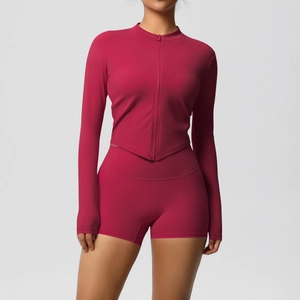 Detail of magenta fitness set with V-hem zip-up jacket and high-waist shorts