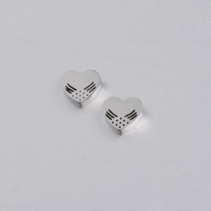 Close-up of polished stainless steel heart stud earrings with angel wing cutouts