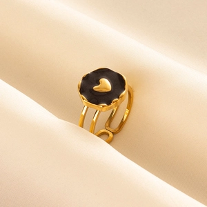 Detailed macro view of 304 stainless steel heart ring on elegant silk fabric background