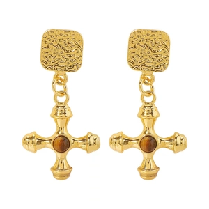 Detailed close-up of retro golden cross earrings featuring hammered texture and tiger eye stones