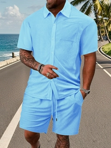 Close-up of light blue waffle texture fabric on men's short sleeve shirt and shorts set
