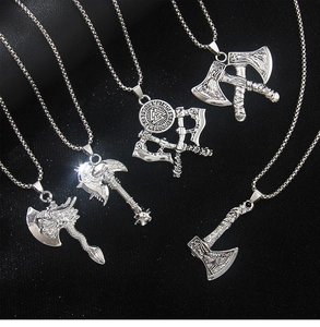 Detailed view of five distinct Viking rune axe pendants in polished silver steel