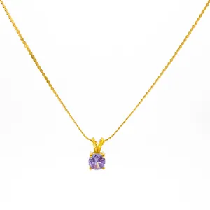 Detail of twist chain necklace featuring a 18K gold plated pendant with purple zircon
