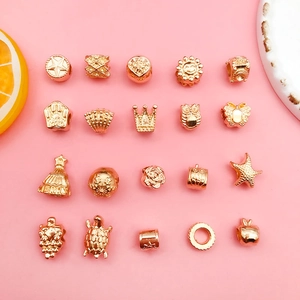 Macro shot of rose gold alloy charms featuring stars, crowns and shells for jewelry making