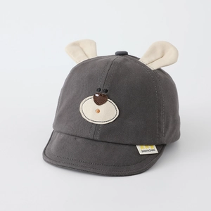 Detail of baby cotton cap featuring 3D animal ears and bear embroidery with side tag