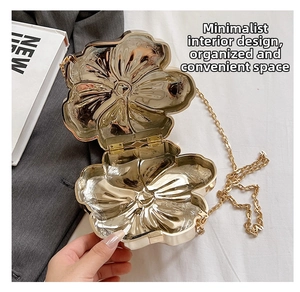 Interior view of flower-shaped gold evening clutch showing clean space and metal chain