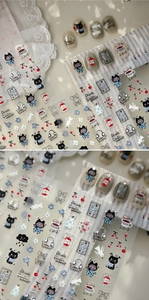Macro detail of 3D embossed nail stickers featuring blue dress cats and red cherries